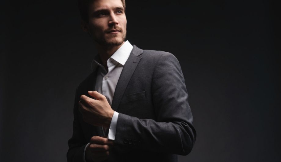 Handsome young businessman adjusting his sleeves