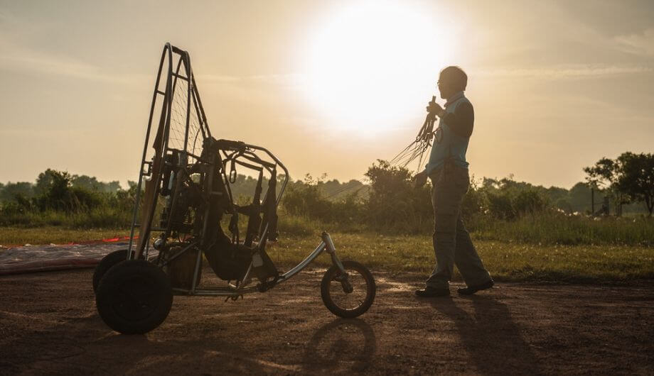 Man with Paramotor flight raining morning-sky