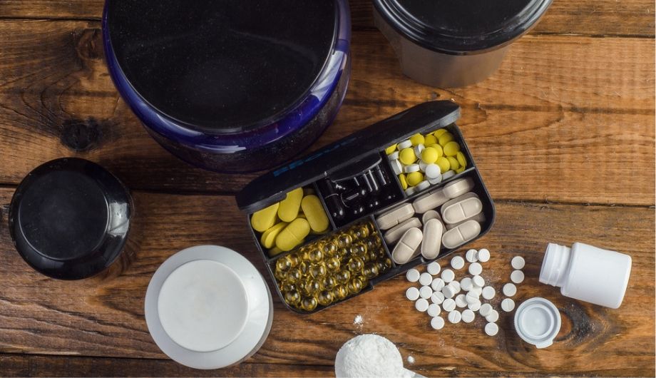 Sport and Fitness Supplement on wood background