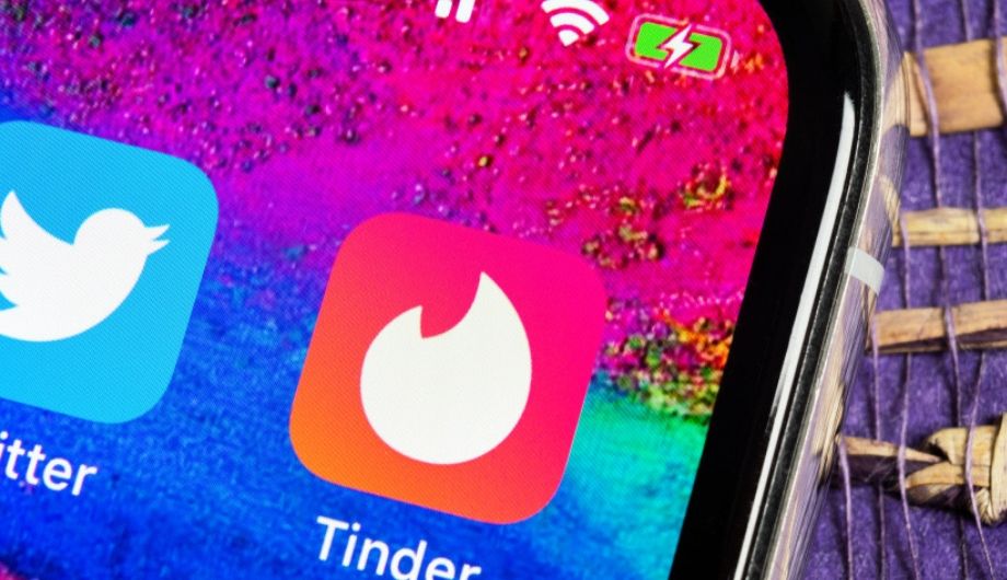 Tinder application icon on Apple iPhone X screen close up