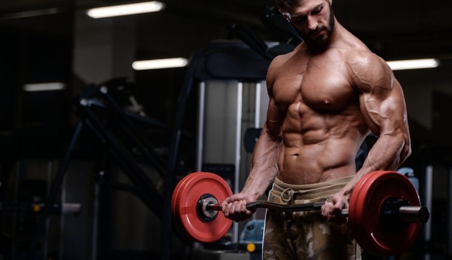 sexy strong bodybuilder athletic fitness man pumping up